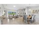 Open-concept living area boasts dining space, modern decor, and sliding glass doors to backyard at 17065 Kellog Ave, Port Charlotte, FL 33954