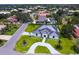Stunning aerial view of the property showcasing its manicured lawn, circular driveway, and elegant architectural design at 180 Lookout Point Dr, Osprey, FL 34229