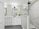 Bathroom with double vanity, modern shower with marble tile, and sleek fixtures at 180 Lookout Point Dr, Osprey, FL 34229