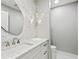 Stylish powder room featuring a decorative mirror, pendant lighting, and marble countertop at 180 Lookout Point Dr, Osprey, FL 34229