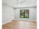 Well lit room with hardwood floors, tray ceiling, ceiling fan and bright window with outside view at 180 Lookout Point Dr, Osprey, FL 34229