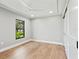 A bright bedroom with hardwood floors and a large window facing the garden at 180 Lookout Point Dr, Osprey, FL 34229