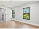A minimal style bedroom with hardwood floors, two large windows and a garden view at 180 Lookout Point Dr, Osprey, FL 34229