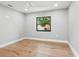 A cozy bedroom with hardwood floors, simple window, and a minimalist design at 180 Lookout Point Dr, Osprey, FL 34229