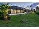 The screened-in patio offers a seamless transition to the lush backyard, with ample space for outdoor activities at 180 Lookout Point Dr, Osprey, FL 34229
