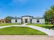 Stunning single-story home with pristine landscaping and a welcoming circular driveway at 180 Lookout Point Dr, Osprey, FL 34229