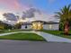 Beautiful single-story home with landscaped front yard and a modern circular driveway at 180 Lookout Point Dr, Osprey, FL 34229