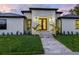 Close up of the front of the house showing the double doors, plants, and stone walkway at 180 Lookout Point Dr, Osprey, FL 34229