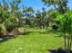 Lush green space surrounded by trees, offering a serene and natural environment at 180 Lookout Point Dr, Osprey, FL 34229