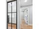 Hallway features a steel trimmed glass door entrance and an adjacent traditional white door at 180 Lookout Point Dr, Osprey, FL 34229