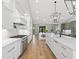 Spacious kitchen with bright white cabinets, hardwood floors, and stainless steel appliances at 180 Lookout Point Dr, Osprey, FL 34229