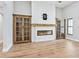 Bright living room with built-in shelves and a modern fireplace with wood mantle at 180 Lookout Point Dr, Osprey, FL 34229