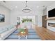 Open-concept living room with hardwood floors and view of modern kitchen at 180 Lookout Point Dr, Osprey, FL 34229