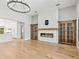 Spacious living room featuring a modern fireplace, hardwood floors, and plenty of light at 180 Lookout Point Dr, Osprey, FL 34229