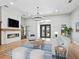 Bright living room featuring a fireplace, modern lighting, and stylish furnishings at 180 Lookout Point Dr, Osprey, FL 34229