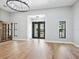 Large open living room with hardwood floors, high ceilings, and lots of natural light at 180 Lookout Point Dr, Osprey, FL 34229