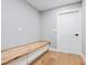Mud room features live edge bench with built in storage and beautiful hardwood floors at 180 Lookout Point Dr, Osprey, FL 34229