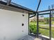 The outdoor shower with black hardware is attached to a screened-in patio, offering a refreshing experience at 180 Lookout Point Dr, Osprey, FL 34229