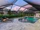 Beautiful screened pool with waterfall feature and poolside lounge chairs create a relaxing outdoor oasis at 180 Lookout Point Dr, Osprey, FL 34229