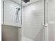 Modern shower featuring glass enclosure, matte black fixtures, and white subway tile at 180 Lookout Point Dr, Osprey, FL 34229