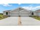Charming single-story home with a two-car garage, nicely maintained lawn, and community street view at 18109 Cropside Trl, Lakewood Ranch, FL 34211