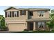 Two-story home featuring a two-car garage, neutral stucco and stone accents, and professionally landscaped front yard at 18146 Wheathouse Pl, Lakewood Ranch, FL 34211