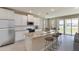 Bright kitchen features granite countertops, stainless steel appliances, and an island with bar stool seating at 18225 Beach Ranch Ter, Lakewood Ranch, FL 34211