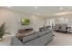 Spacious living room with neutral paint, stylish seating, and a view into the dining room at 18225 Beach Ranch Ter, Lakewood Ranch, FL 34211
