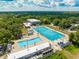 A beautiful aerial shot of a community pool with several swimming areas, and lush green trees at 2110 Craft Ln, Sarasota, FL 34239