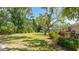 Landscaped backyard with mature trees at 2110 Craft Ln, Sarasota, FL 34239