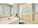 A vintage, retro bathroom features a shower, toilet, sink and light blue and yellow accents at 2110 Craft Ln, Sarasota, FL 34239