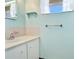 A modest bathroom with a white sink and vanity cabinet, window and mosaic backsplash at 2110 Craft Ln, Sarasota, FL 34239