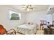 Bedroom with a ceiling fan, window, and a cozy quilt on the bed at 2110 Craft Ln, Sarasota, FL 34239