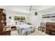 Inviting bedroom with a ceiling fan, carpeted floors, and a view of the outdoors at 2110 Craft Ln, Sarasota, FL 34239