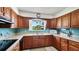 This charming kitchen has wood cabinets, neutral countertops, and a window view of the neighborhood at 2110 Craft Ln, Sarasota, FL 34239