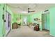 Green living room with a ceiling fan, carpeted floors, and sliding glass door to Florida room at 2110 Craft Ln, Sarasota, FL 34239