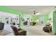 Open-concept living area with green walls and sliding glass doors to the back of the house at 2110 Craft Ln, Sarasota, FL 34239