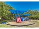 Colorful community playground featuring slides and climbing structures under shaded canopy at 2110 Craft Ln, Sarasota, FL 34239