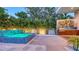Backyard patio featuring a hot tub, built in outdoor kitchen, and a modern art mural at 2135 Hyde Park St, Sarasota, FL 34239