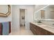 Bathroom featuring double vanity, large mirrors, and a separate toilet room at 2135 Hyde Park St, Sarasota, FL 34239