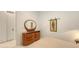 Bedroom with white walls, dresser with an oval mirror, and closet at 2135 Hyde Park St, Sarasota, FL 34239