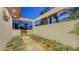 Picturesque courtyard with landscaped walkway, elegant wall, and glimpse of architectural design at 2135 Hyde Park St, Sarasota, FL 34239