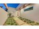 Tranquil courtyard featuring a stone walkway, vibrant greenery, and a quaint bench, showcasing modern design at 2135 Hyde Park St, Sarasota, FL 34239