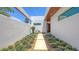 Charming courtyard with modern design and inviting walkway framed by lush greenery and a cozy bench at 2135 Hyde Park St, Sarasota, FL 34239