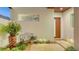 Charming courtyard featuring a stylish bench, a lush fern, and an inviting entrance, complemented by modern design at 2135 Hyde Park St, Sarasota, FL 34239