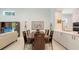 Bright dining room with hardwood table, seating for eight, and view to the living area at 2135 Hyde Park St, Sarasota, FL 34239