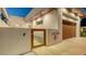 Stylish modern home with a unique gate design and wood door, enhanced by clean, elegant architecture at 2135 Hyde Park St, Sarasota, FL 34239