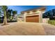 Striking modern home with a wooden garage door, unique architectural elements, and mature landscaping at 2135 Hyde Park St, Sarasota, FL 34239