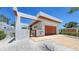 Sleek modern home showcasing its clean lines, stylish architecture, and inviting wood garage door at 2135 Hyde Park St, Sarasota, FL 34239
