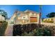 Modern home with sleek architecture, wood garage door, lush greenery, and striking palm tree at 2135 Hyde Park St, Sarasota, FL 34239
